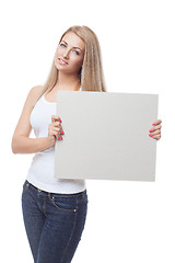 Image showing Beautiful blond girl holding blank poster