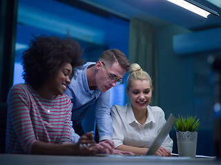 Image showing Multiethnic startup business team in night office