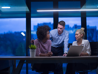 Image showing Multiethnic startup business team in night office