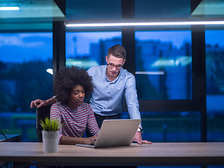 Image showing Multiethnic startup business team in night office