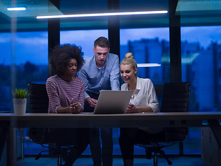 Image showing Multiethnic startup business team in night office