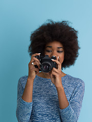 Image showing african american girl taking photo on a retro camera