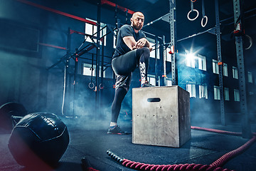 Image showing Man standing during exercises in the fitness gym. CrossFit.