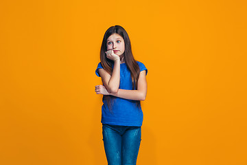 Image showing Young serious thoughtful teen girl. Doubt concept.