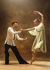 Image showing Flexible young modern dance couple posing in studio.