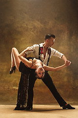 Image showing Flexible young modern dance couple posing in studio.