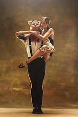 Image showing Flexible young modern dance couple posing in studio.