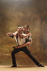 Image showing Flexible young modern dance couple posing in studio.