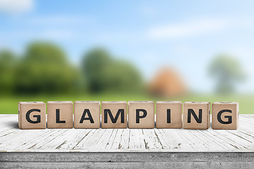 Image showing Glamping sign on wooden planks in the summer