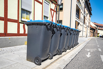 Image showing Eight garbage cans on the street