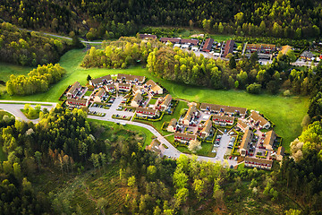 Image showing Small village seen from above surrounded by forest
