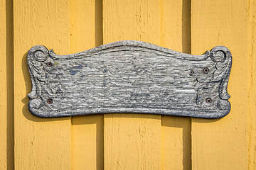 Image showing Wooden vintage sign on yellow planked wall