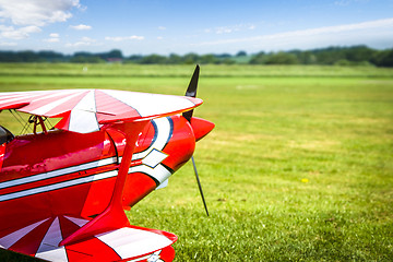 Image showing Retro airplane ready to take of on a green field