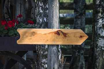 Image showing Wooden arrow sign outside a house