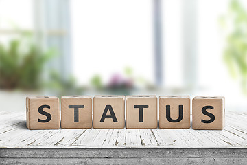 Image showing Status sign made of wood on a table