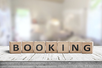 Image showing Booking sign on a wooden desk in a room