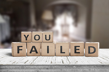 Image showing You failed sign on a wooden table in a dark room