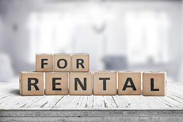 Image showing Sign with the text for rent on a desk