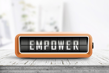 Image showing Empower message sign on a wooden desk