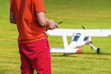 Image showing Man flying a model airplane with a controller