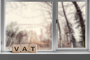 Image showing VAT sign on a window sill in the morning sunrise