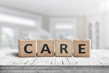 Image showing Care sign on a white table in a bright room