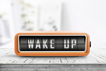 Image showing Wake up alarm clock on a table in a bright room