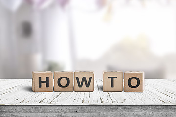 Image showing How to sign in a room on a wooden table