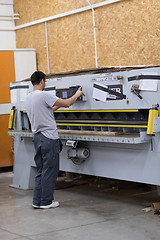 Image showing worker in a factory of wooden furniture