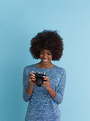 Image showing african american girl taking photo on a retro camera