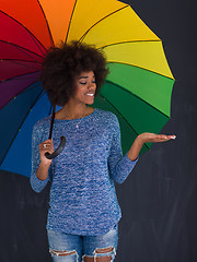 Image showing african american woman holding a colorful umbrella