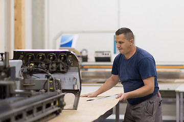 Image showing worker in a factory of wooden furniture