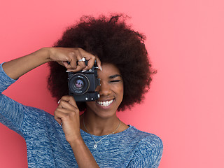 Image showing young black girl taking photo on a retro camera