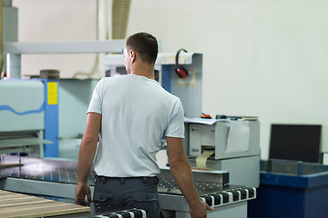 Image showing worker in a factory of wooden furniture