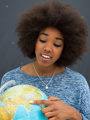 Image showing black woman holding Globe of the world