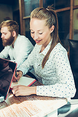 Image showing Young cheerful people smile and gesture while relaxing in pub.