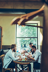 Image showing Young cheerful people smile and gesture while relaxing in pub.