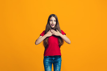 Image showing Beautiful teen girl looking suprised isolated on orange