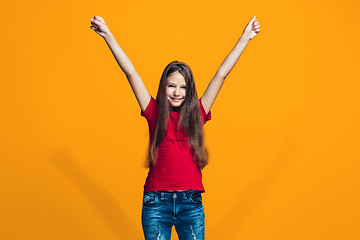 Image showing Happy success teen girl celebrating being a winner. Dynamic energetic image of female model