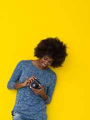 Image showing young african american girl taking photo on a retro camera