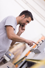 Image showing engineer in front of wood cutting machine