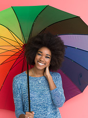Image showing afro american woman holding a colorful umbrella