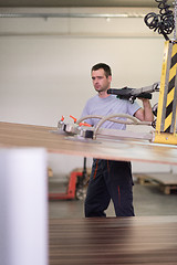 Image showing worker in a factory of wooden furniture