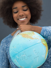 Image showing black woman holding Globe of the world