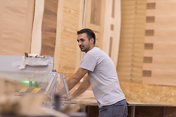 Image showing worker in a factory of wooden furniture