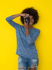 Image showing young african american girl taking photo on a retro camera