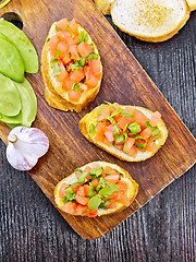 Image showing Bruschetta with tomato and spinach on board top