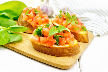 Image showing Bruschetta with tomato and spinach on white table