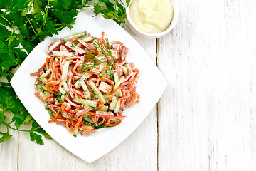 Image showing Salad of sausage and spicy carrots with mayonnaise on light boar