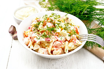 Image showing Salad of surimi and eggs with mayonnaise on table